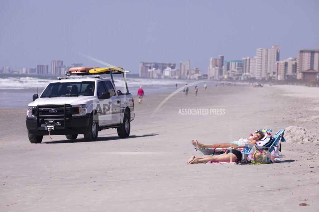 North Myrtle Beach opened public beach access after Governor Henry McMaster removed his order allowing local municipalities to make their own decisions as of noon on Tuesday, April 20, 2020 in North Myrtle Beach, S.C. (Jason Lee/The Sun News via AP)