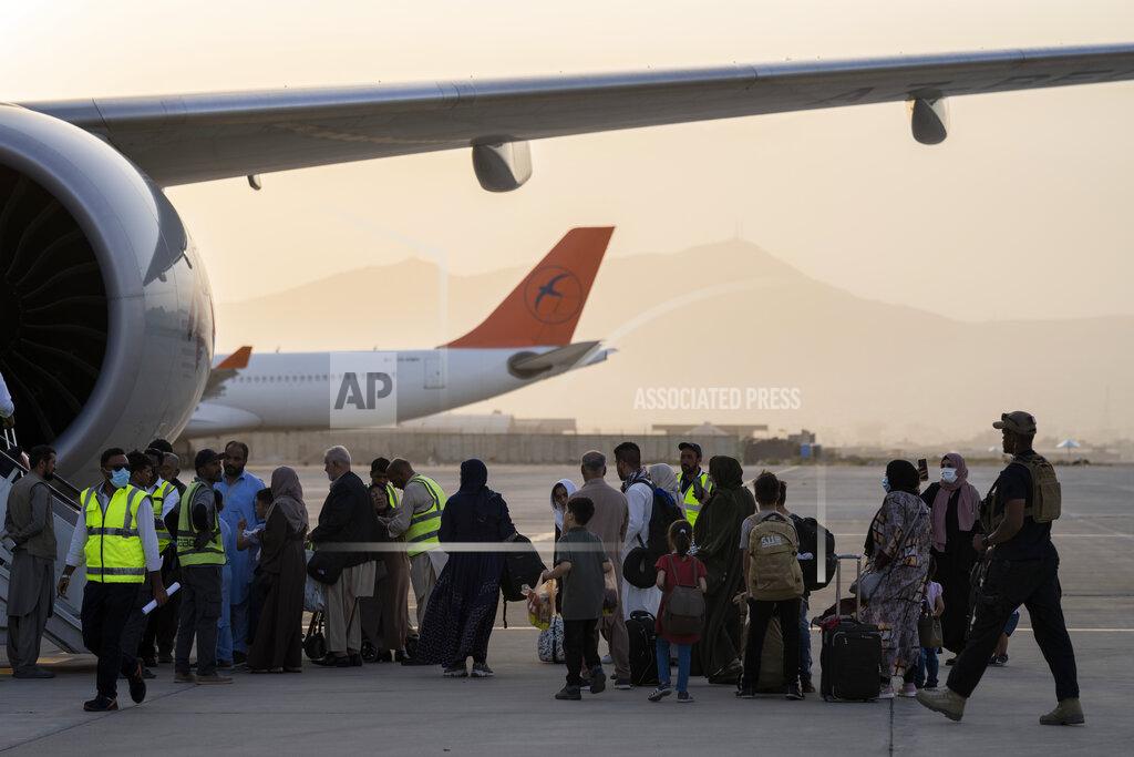 Bernat Armangue Foreigners board a Qatar Airways aircraft at the airport in Kabul, Afghanistan, Thursday, Sept. 9, 2021. Some 200 foreigners, including Americans, flew out of Afghanistan on an international commercial flight from Kabul airport on Thursday, the first such large-scale departure since U.S and foreign forces concluded their frantic withdrawal at the end of last month. (AP Photo/Bernat Armangue)