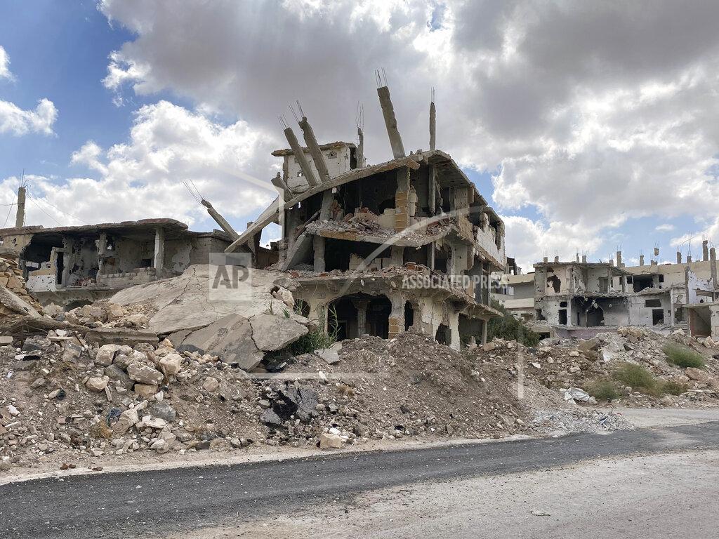 Uncredited Buildings damaged by Syrian government forces following clashes with rebel fighters are seen in the southern city of Daraa, Syria, Sunday, Sept 12, 2021. A Russian-negotiated deal went into effect last week to end a government siege and intense fighting in the city of Daraa and with rebel fighters holed up Daraa al-Balad forcing some of them to go to the rebel-held north and others to surrender their weapons in return for amnesty. (AP Photo)