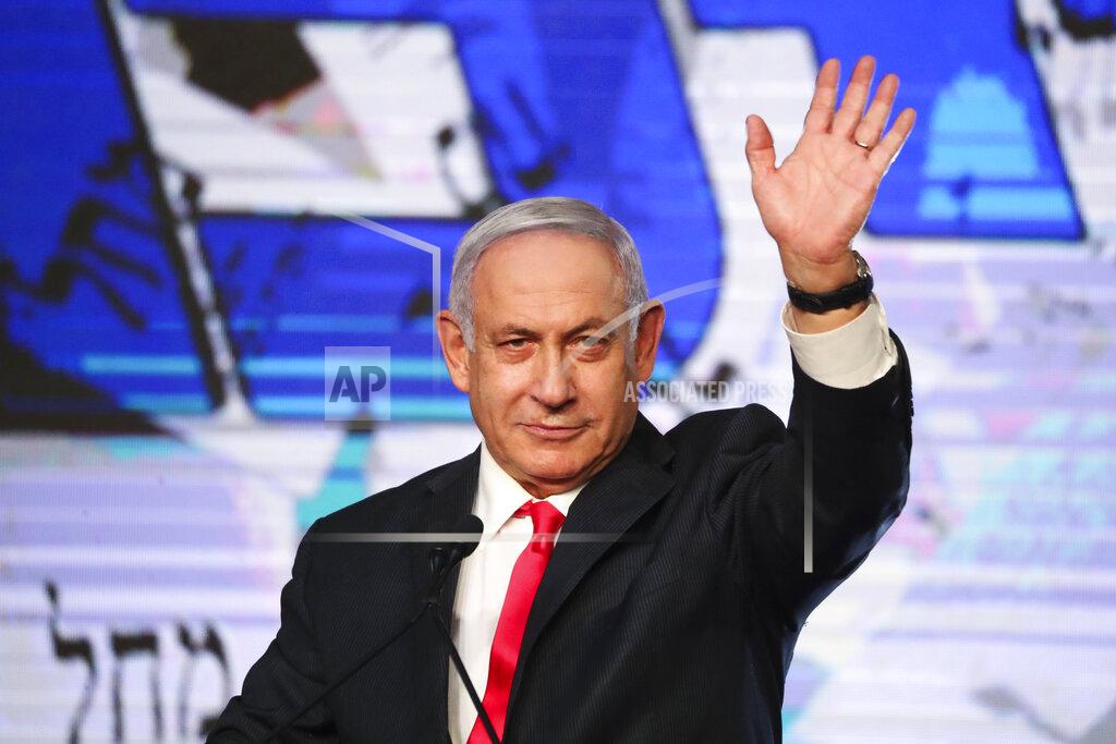 Ariel Schalit Israeli Prime Minister Benjamin Netanyahu waves to his supporters after the first exit poll results for the Israeli parliamentary elections at his Likud party's headquarters in Jerusalem, Wednesday, March. 24, 2021. (AP Photo/Ariel Schalit)