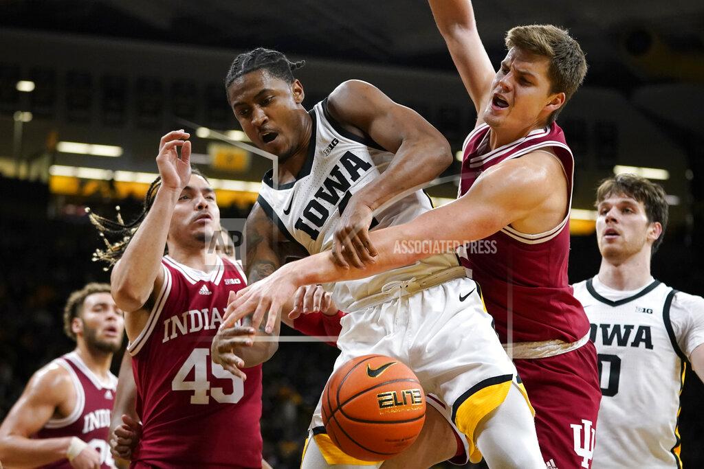 Charlie Neibergall Iowa guard Ahron Ulis, center, fights for a loose ball with Indiana guard Parker Stewart (45) and forward Miller Kopp, right, during the second half of an NCAA college basketball game, Thursday, Jan. 13, 2022, in Iowa City, Iowa. (AP Photo/Charlie Neibergall)