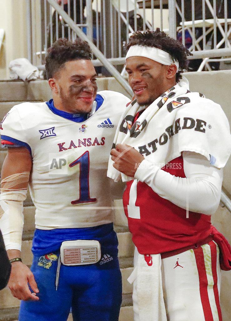 Alonzo Adams Kansas safety Bryce Torneden, left, and Oklahoma quarterback Kyler Murray, right, meet outside the Kansas locker room following an NCAA college football game in Norman, Okla., Saturday, Nov. 17, 2018. Oklahoma won 55-40. (AP Photo/Alonzo Adams)