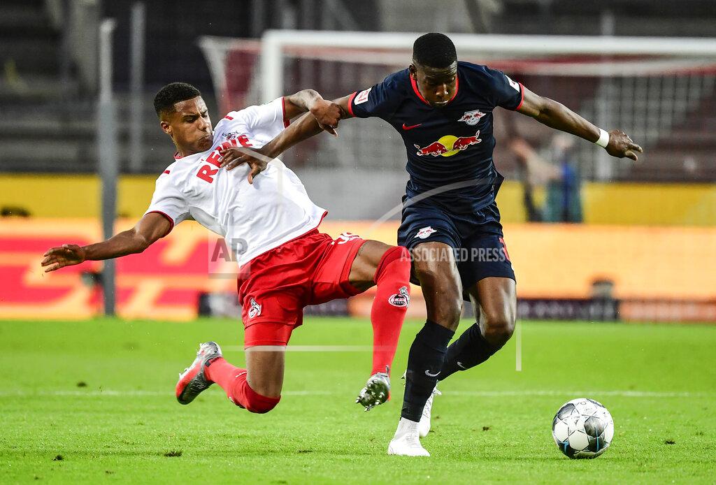 Ina Fassbender Cologne's Spanish defender Jorge Mere, left, and Leipzig's French midfielder Christopher Nkunku challenge for the ball during the German Bundesliga soccer match between 1. FC Cologne and RB Leipzig, in Cologne, Germany, Monday, June 1, 2020. Because of the coronavirus outbreak all soccer matches of the German Bundesliga take place without spectators. (Ina Fassbender/Pool via AP)