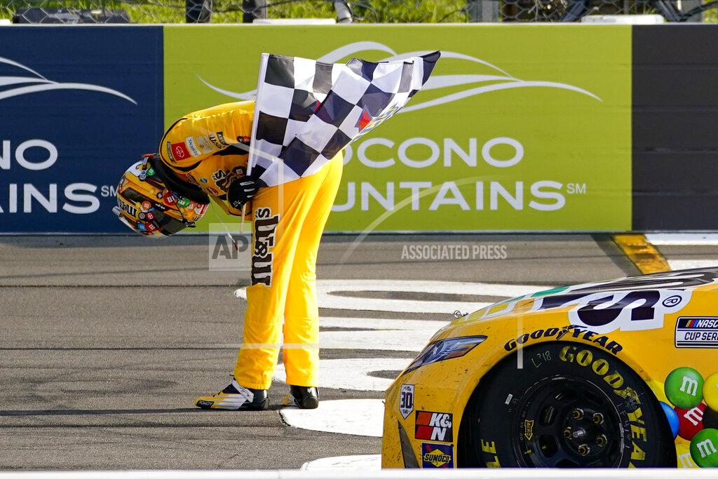 Matt Slocum Kyle Busch takes a bow with the checker flag after winning a NASCAR Cup Series auto race at Pocono Raceway, Sunday, June 27, 2021, in Long Pond, Pa. (AP Photo/Matt Slocum)