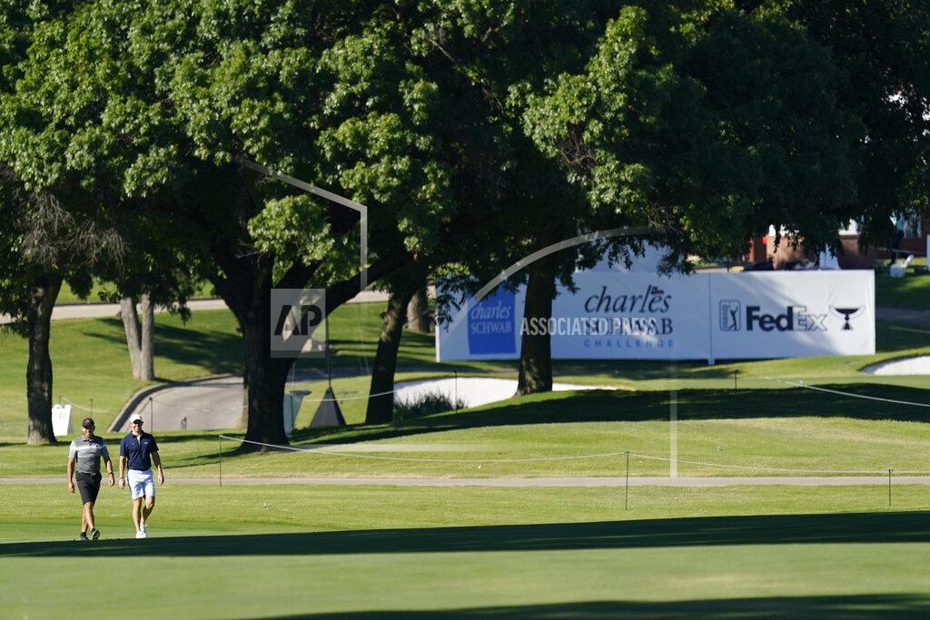 Sergio Garcia, of Spain, and Rory McIlroy, of Northern Ireland, walk down the seventh fairway during practice for the Charles Schwab Challenge golf tournament at the Colonial Country Club in Fort Worth, Texas, Wednesday, June 10, 2020. (AP Photo/David J. Phillip)