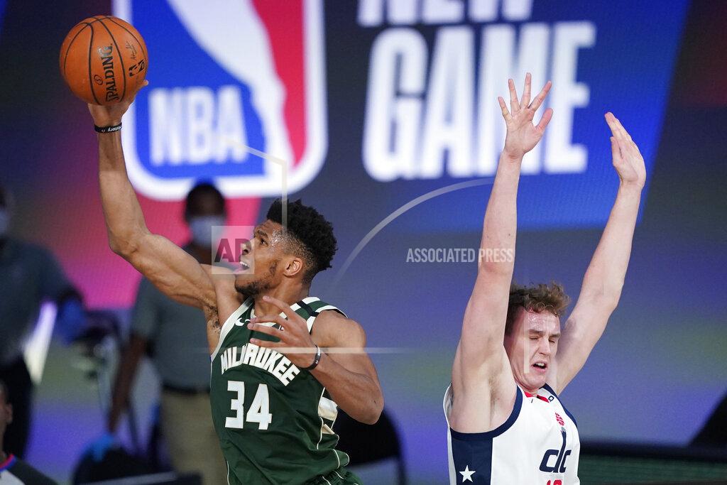Ashley Landis Milwaukee Bucks' Giannis Antetokounmpo (34) drives to the basket past Washington Wizards' Anzejs Pasecniks, right, during the first half of an NBA basketball game, Tuesday, Aug. 11, 2020, in Lake Buena Vista, Fla. (AP Photo/Ashley Landis, Pool)
