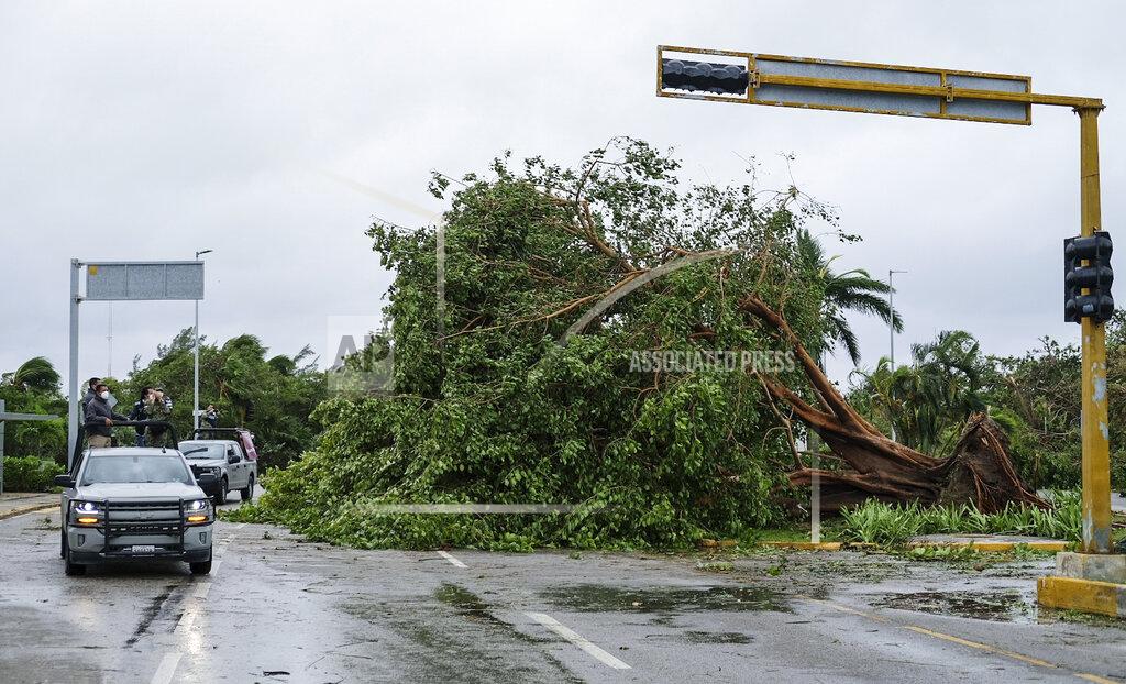 Victor Ruiz Garcia Soldiers survey damage from Hurricane Delta in Cancun, Mexico, Wednesday, Oct. 7, 2020. Hurricane Delta made landfall Wednesday just south of the Mexican resort of Cancun as a Category 2 storm, downing trees and knocking out power to some resorts along the northeastern coast of the Yucatan Peninsula. (AP Photo/Victor Ruiz Garcia)