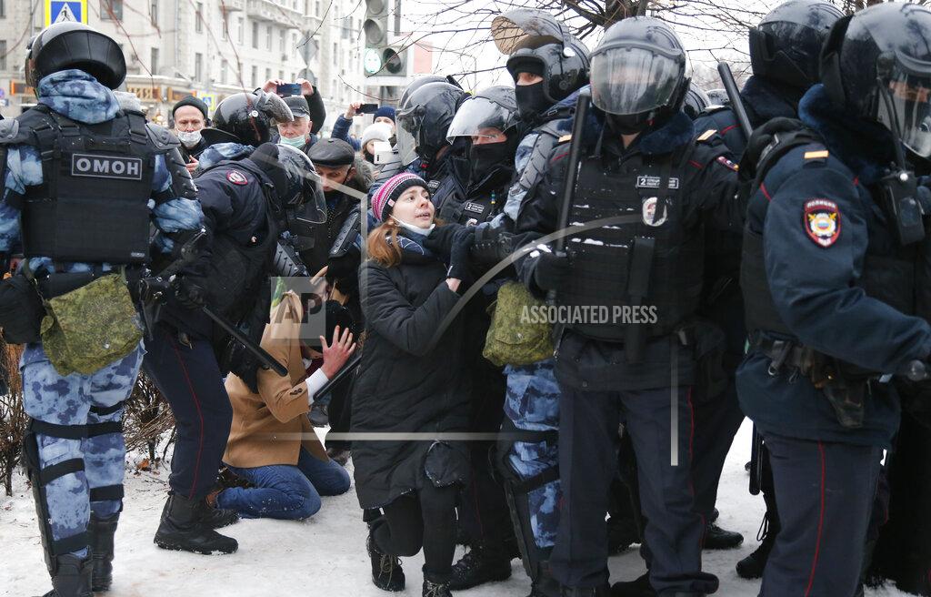 Alexander Zemlianichenko Police detain a man during a protest against the jailing of opposition leader Alexei Navalny in Moscow, Russia, Saturday, Jan. 23, 2021. Russian police on Saturday arrested hundreds of protesters who took to the streets in temperatures as low as minus-50 C (minus-58 F) to demand the release of Alexei Navalny, the country's top opposition figure. A Navalny, President Vladimir Putin's most prominent foe, was arrested on Jan. 17 when he returned to Moscow from Germany, where he had spent five months recovering from a severe nerve-agent poisoning that he blames on the Kremlin. (AP Photo/Alexander Zemlianichenko)