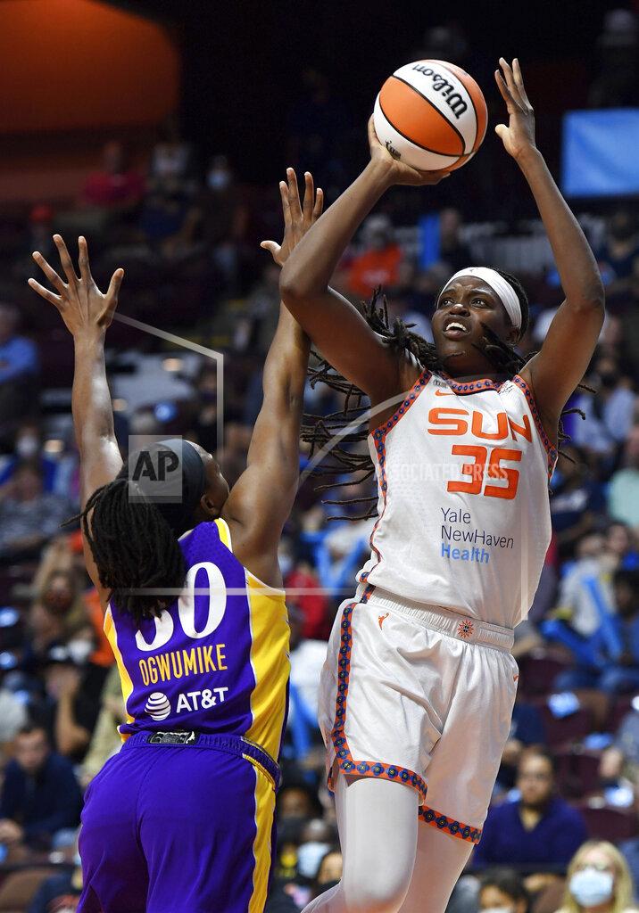 Sean D. Elliot FILE - Connecticut Sun forward Jonquel Jones (35) shoots over Los Angeles Sparks forward Nneka Ogwumike (30) during a WNBA basketball game in Uncasville, Conn., in this Saturday, Aug. 28, 2021, file photo. This year, the 6-foot-6 Jones is the unanimous choice AP Player of the Year honors by the 14-member panel, announced Wednesday, Sept. 22, 2021. (Sean D. Elliot/The Day via AP, File)