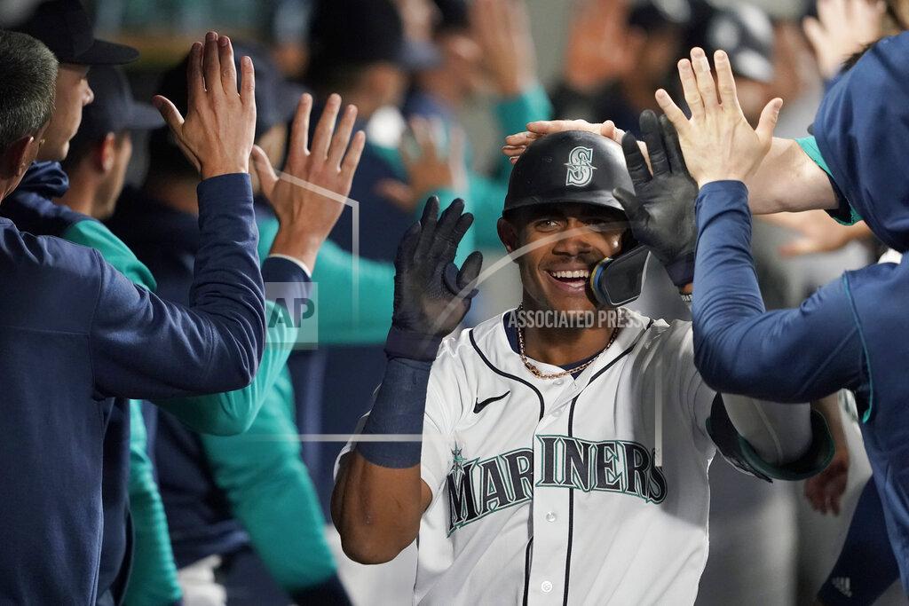 Ted S. Warren Seattle Mariners' Julio Rodriguez is congratulated in the dugout after hitting a two-run home run against the Oakland Athletics during the fifth inning of a baseball game Tuesday, May 24, 2022, in Seattle. (AP Photo/Ted S. Warren)