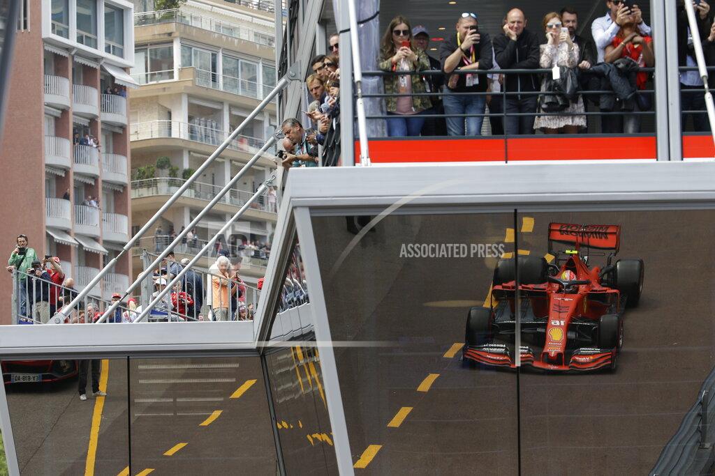 Luca Bruno Ferrari driver Charles Leclerc of Monaco is reflected on the glass of the paddock during the second practice session at the Monaco racetrack, in Monaco, Thursday, May 23, 2019. The Formula one race will be held on Sunday. (AP Photo/Luca Bruno)