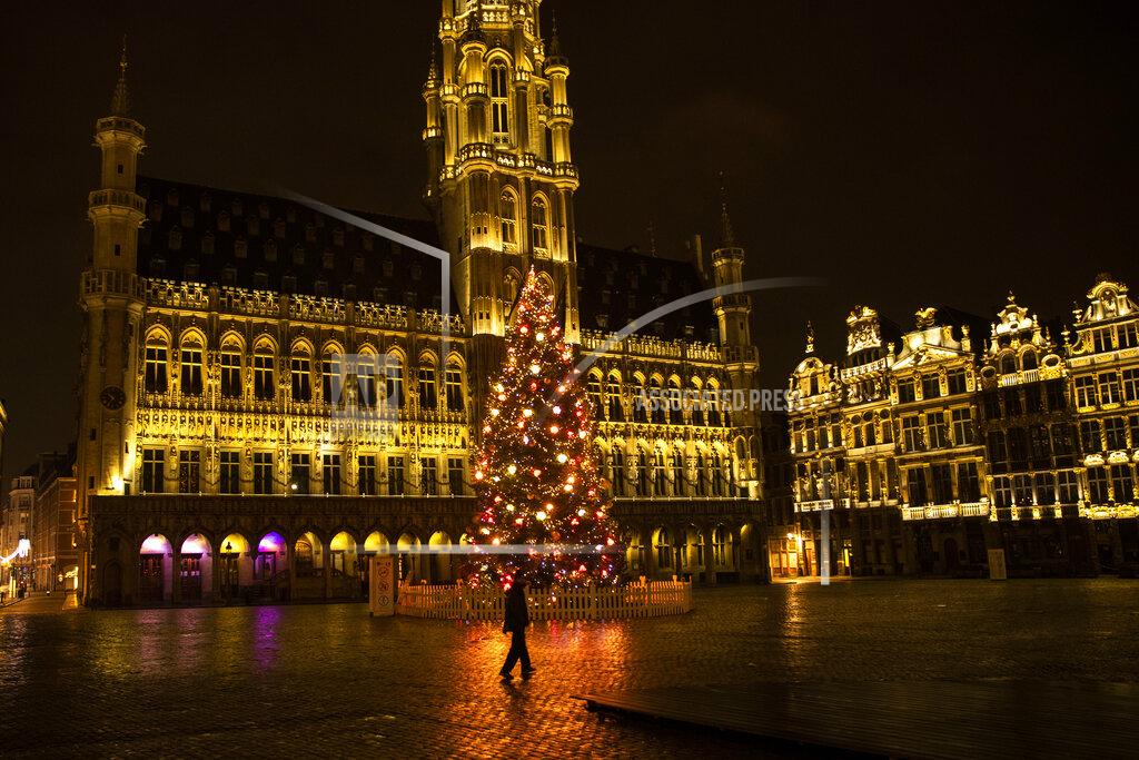 Francisco Seco A man walks along a virtually empty Grand Place square during a curfew in downtown Brussels, Thursday, Dec. 31, 2020. As the world says goodbye to 2020, there will be countdowns and live performances, but no massed jubilant crowds in traditional gathering spots like the Champs Elysees in Paris and New York City's Times Square this New Year's Eve. The virus that ruined 2020 has led to cancelations of most fireworks displays and public events in favor of made-for-TV-only moments in party spots like London and Rio de Janeiro. (AP Photo/Francisco Seco)