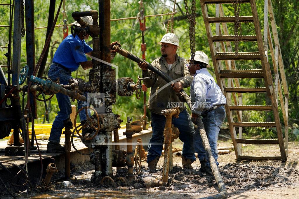 Eric Gay Oil well workers prepare to plug an orphaned well on the Rooke family ranch, Tuesday, May 18, 2021, near Refugio, Texas. Oil and gas drilling began on the ranch in the 1920s and there were dozens of orphaned wells that needed to be plugged for safety and environmental protection. (AP Photo/Eric Gay)