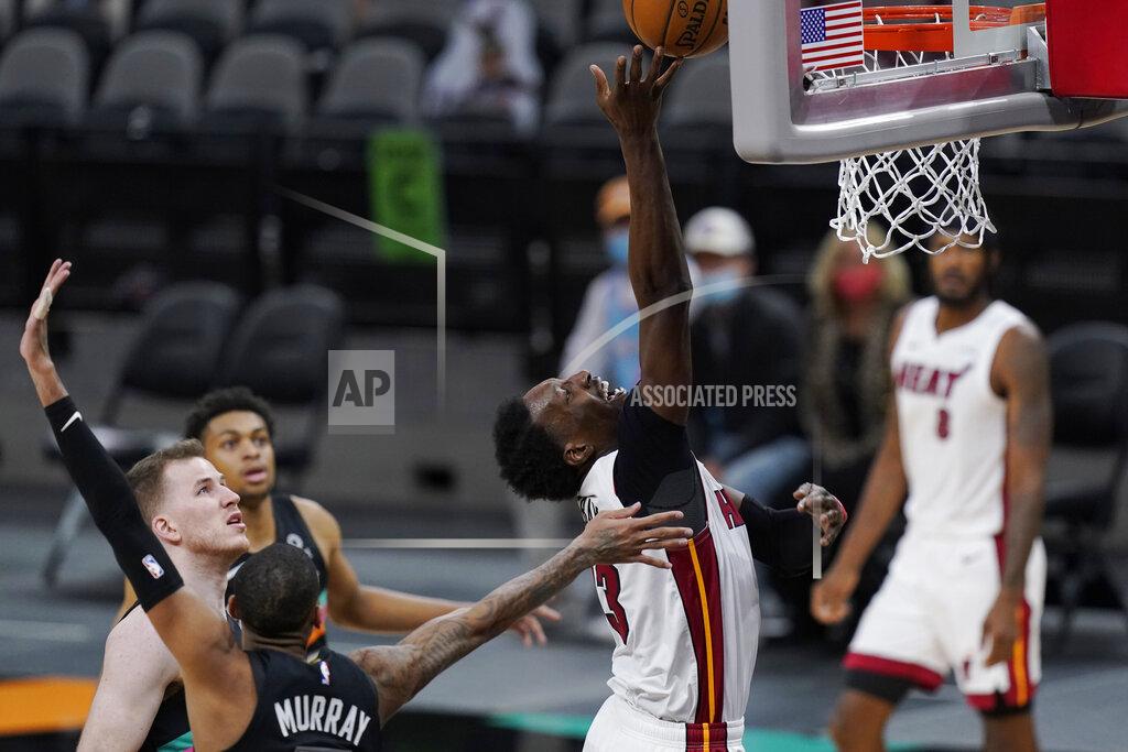 Eric Gay Miami Heat center Bam Adebayo (13) drives to the basket past San Antonio Spurs guard Dejounte Murray during the second half of an NBA basketball game in San Antonio, Wednesday, April 21, 2021. (AP Photo/Eric Gay)