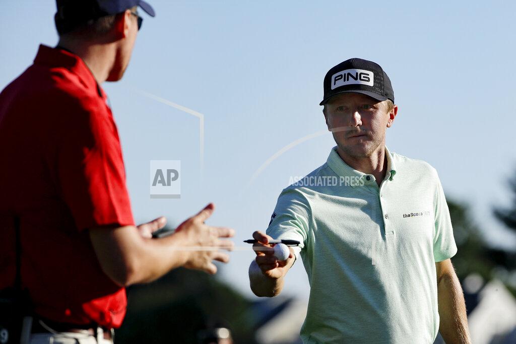 Frank Franklin Ii Mackenzie Hughes, right, of Canada, gives a signed ball to a volunteer after finishing the second round of the Travelers Championship golf tournament at TPC River Highlands, Friday, June 26, 2020, in Cromwell, Conn. (AP Photo/Frank Franklin II)