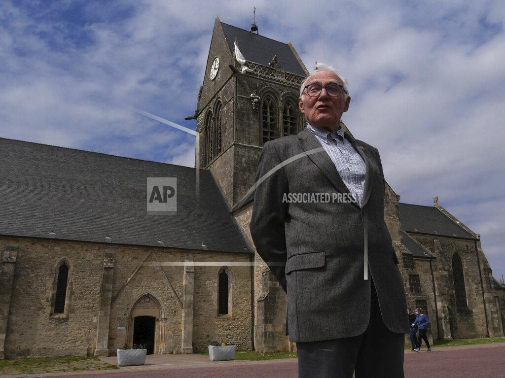 Nicolas Garriga Henri-Jean Renaud, 86, poses outside the church in Sainte-Mere-Eglise, Normandy, Friday, June 4, 2021. Henri-Jean Renaud, 86, remembers D-Day like it was yesterday. He was a young boy and was hidden in his family home in Sainte-Mere-Eglise when more than 800 planes bringing U.S. paratroopers flew over the town while German soldiers machine guns were firing at them. (AP Photo/Nicolas Garriga)