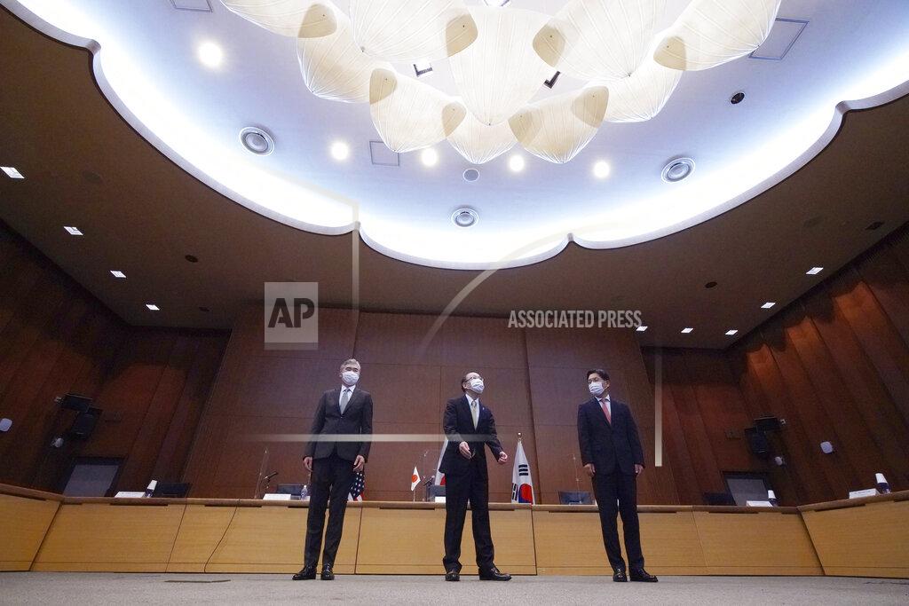 Eugene Hoshiko Japanese Foreign Ministry's Director-General of the Asian and Oceanian Affairs Bureau Takehiro Funakoshi, center, U.S. Special Representative for North Korea, Sung Kim, left, and South Korea's Special Representative for Korean Peninsula Peace and Security Affairs Noh Kyu-duk prepare to attend their trilateral meeting on North Korea's issues at Foreign Ministry Tuesday, Sept. 14, 2021 n Tokyo. (AP Photo/Eugene Hoshiko)