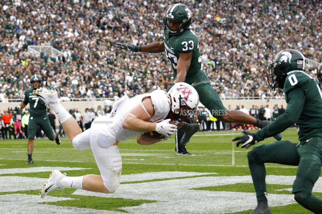 Al Goldis Minnesota tight end Nick Kallerup, left, catches a pass for a touchdown against Michigan State's Kendell Brooks (33) and Charles Brantley, right, during the second half of an NCAA college football game, Saturday, Sept. 24, 2022, in East Lansing, Mich. Minnesota won 34-7. (AP Photo/Al Goldis)