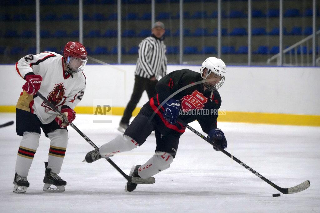Mark Schiefelbein Members of the "1979" hockey club compete during a hockey match at a rink in Beijing, Wednesday, Jan. 12, 2022. Spurred by enthusiasm after China was awarded the 2022 Winter Olympics, the members of a 1970s-era youth hockey team, now around 60 years old, have reunited decades later to once again take to the ice. (AP Photo/Mark Schiefelbein)