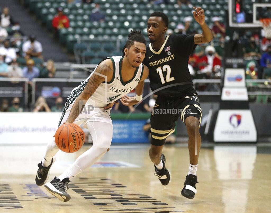 Marco Garcia Hawaii guard Noel Coleman (4) dribbles around Vanderbilt guard Trey Thomas (12) in the second half of an NCAA college basketball game Wednesday, Dec. 22, 2021, in Honolulu. (AP Photo/Marco Garcia)