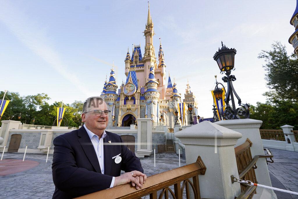 John Raoux George Kalogridis, president of segment development and enrichment for Disney Parks, stands in front of the Cinderella Castle at the Magic Kingdom theme park at Walt Disney World Monday, Aug. 30, 2021, in Lake Buena Vista, Fla. Kalogridis was one of 6,000 employees that was working at the theme park on opening day in 1971. (AP Photo/John Raoux)