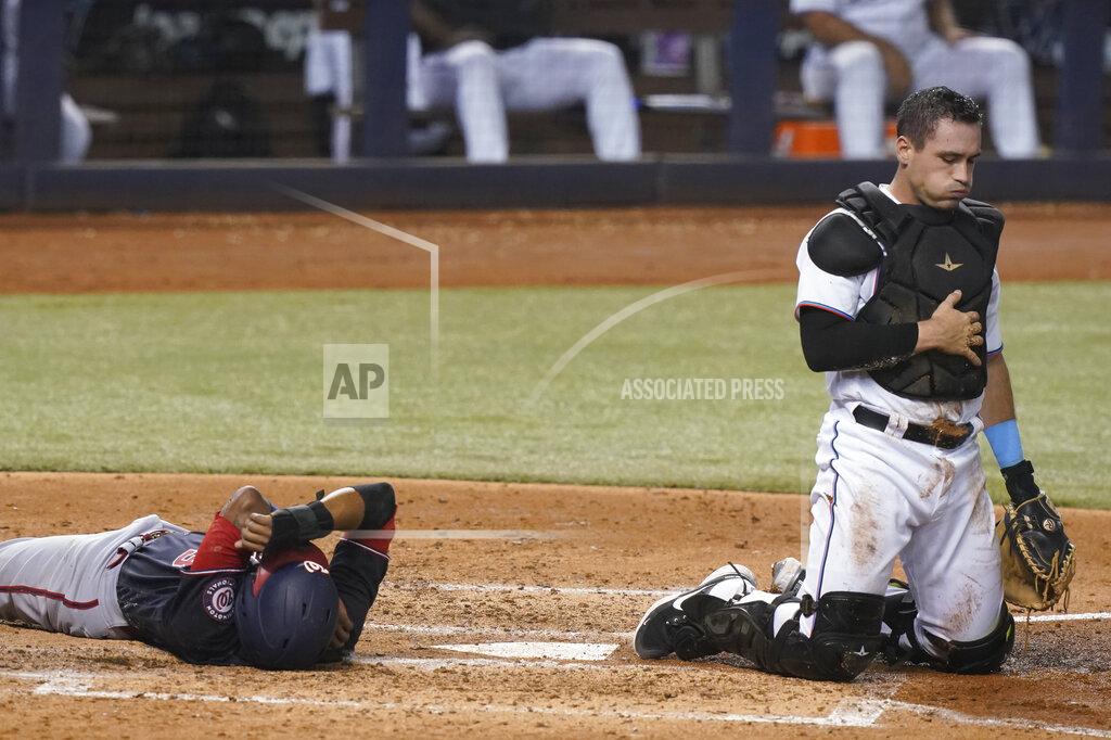 Marta Lavandier Washington Nationals' Alcides Escobar and Miami Marlins catcher Nick Fortes take their time getting up after colliding at home plate in the sixth inning of a baseball game, Tuesday, Sept. 21, 2021, in Miami. Escobar scored on the play. (AP Photo/Marta Lavandier)