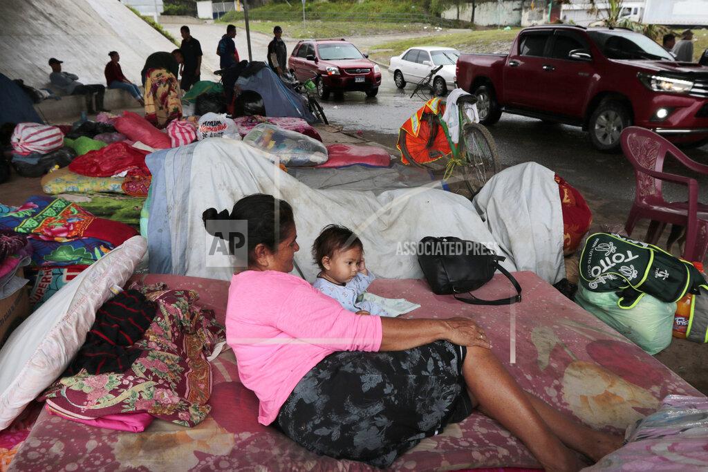Delmer Martinez Hurricane victims take refuge under a bridge in San Pedro Sula, Honduras, Saturday, Nov. 21, 2020. Shelters for people whose homes were flooded or damaged by hurricanes Eta and Iota in Honduras are now so crowded that thousands of victims have taken refuge under highway overpasses or bridges. The Red Cross estimates that about 4.2 million people were affected by the back-to-back hurricanes in November in Honduras, Nicaragua and Guatemala. (AP Photo/Delmer Martinez)