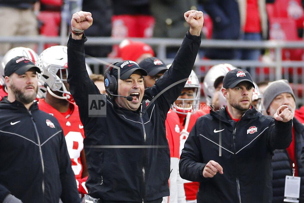 FILE - In this Nov. 23, 2019, file photo, Ohio State head coach Ryan Day celebrates on the sideline against Penn State during an NCAA college football game, in Columbus, Ohio. Heading into this year’s slate of conference title games a case could be made that No. 1 LSU (No. 2 CFP), No. 2 Ohio State (No. 1 CFP) and No. 3 Clemson (No. 3 CFP) have all done enough already to lose their conference championship games and still get in the College Football Playoff.(AP Photo/Jay LaPrete, File)