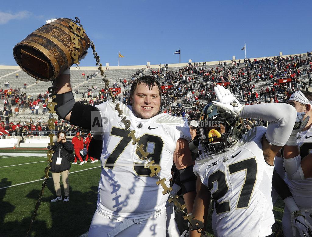Darron Cummings Purdue's Matt McCann (79) and Navon Mosley (27) celebrates with the Old Oaken Bucket after Purdue defeated Indiana, 28-21, in an NCAA college football game, Saturday, Nov. 24, 2018, in Bloomington, Ind. (Darron Cummings)
