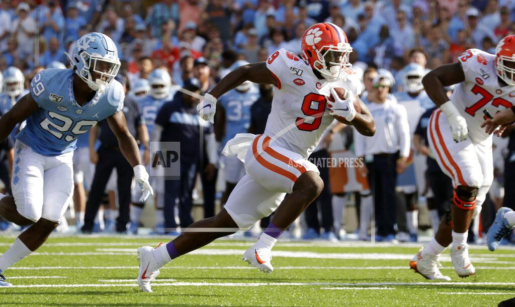 Chris Seward Clemson's Travis Etienne (9) evades North Carolina Tar Heels's Storm Duck (29) as he runs for a touchdown during the second quarter of an NCAA college football game in Chapel Hill, N.C., Saturday, Sept. 28, 2019. (AP Photo/Chris Seward)