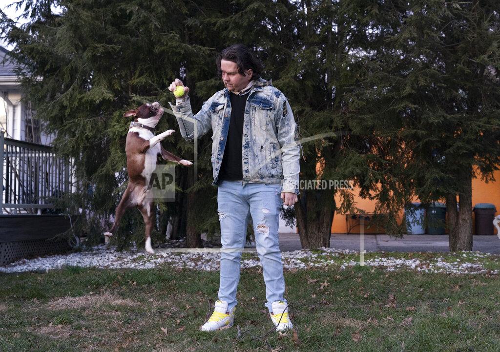 Mark Lennihan Joe DiMeo plays ball with his dog Buster in the backyard of his house in Clark, N.J., Thursday, Jan. 28, 2021, six months after an extremely rare double hand and face transplant. “In the future, I have a lot more plans for myself,” he said. “You got a new chance at life. You really can’t give up.” (AP Photo/Mark Lennihan)
