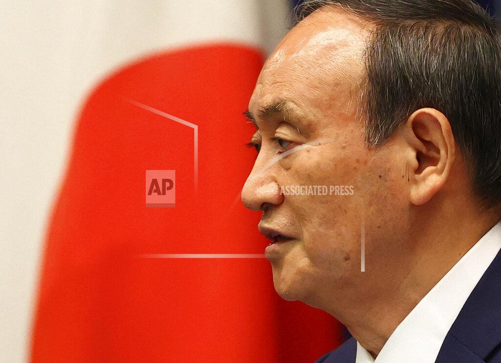 Issei Kato Japan's Prime Minister Yoshihide Suga attends a news conference on Japan's response to the coronavirus pandemic at his official residence during the Tokyo 2020 Olympic Games in Tokyo, Japan, Friday, July 30, 2021. Suga expanded a coronavirus state of emergency to four more areas in addition to Tokyo on Friday following record spikes in infections as the capital hosts the Olympics. (Issei Kato/Pool Photo via AP)