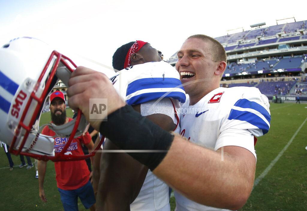 Ron Jenkins SMU quarterbacks William Brown, left, and Shane Buechele, right, celebrate after they defeated TCU in an NCAA college football game Saturday, Sept. 21, 2019, in Fort Worth, Texas. (AP Photo/Ron Jenkins)