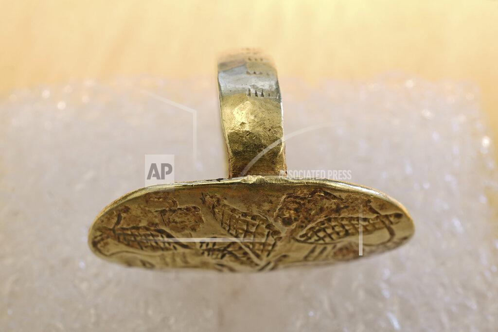 Uncredited This undated photo provided by the Greek Culture Ministry on Friday, May 20, 2022, shows a gold Mycenaean-era ring which was returned by Swedish officials who provided full assistance with documenting the artifact and its provenance. A more than 3,000-year-old gold signet ring that was stolen from an Aegean Sea island in World War II, crossed the Atlantic, was bought by a Nobel Prize-winning Hungarian scientist and ended up in a Swedish museum, has found its way back to Greece. (Greek Culture Ministry via AP)