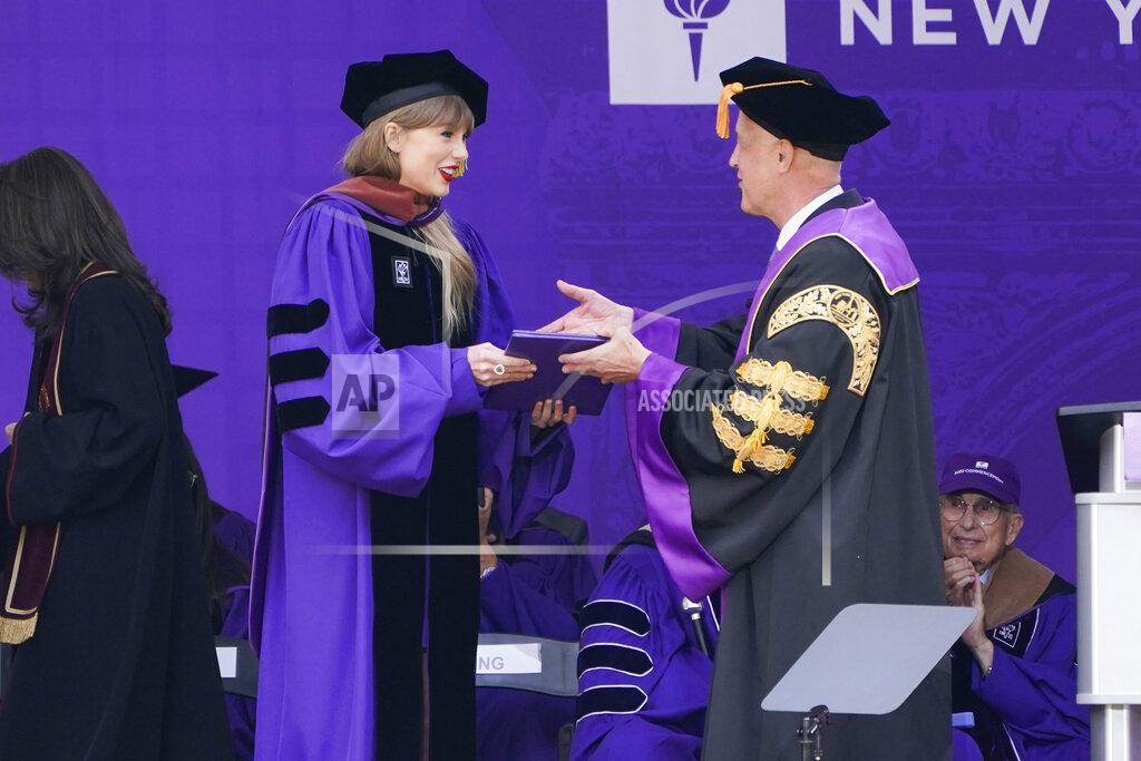 Seth Wenig Taylor Swift receives her honorary degree from New York University president Andrew Hamilton during a graduation ceremony for New York University at Yankee Stadium in New York, Wednesday, May 18, 2022. (AP Photo/Seth Wenig)