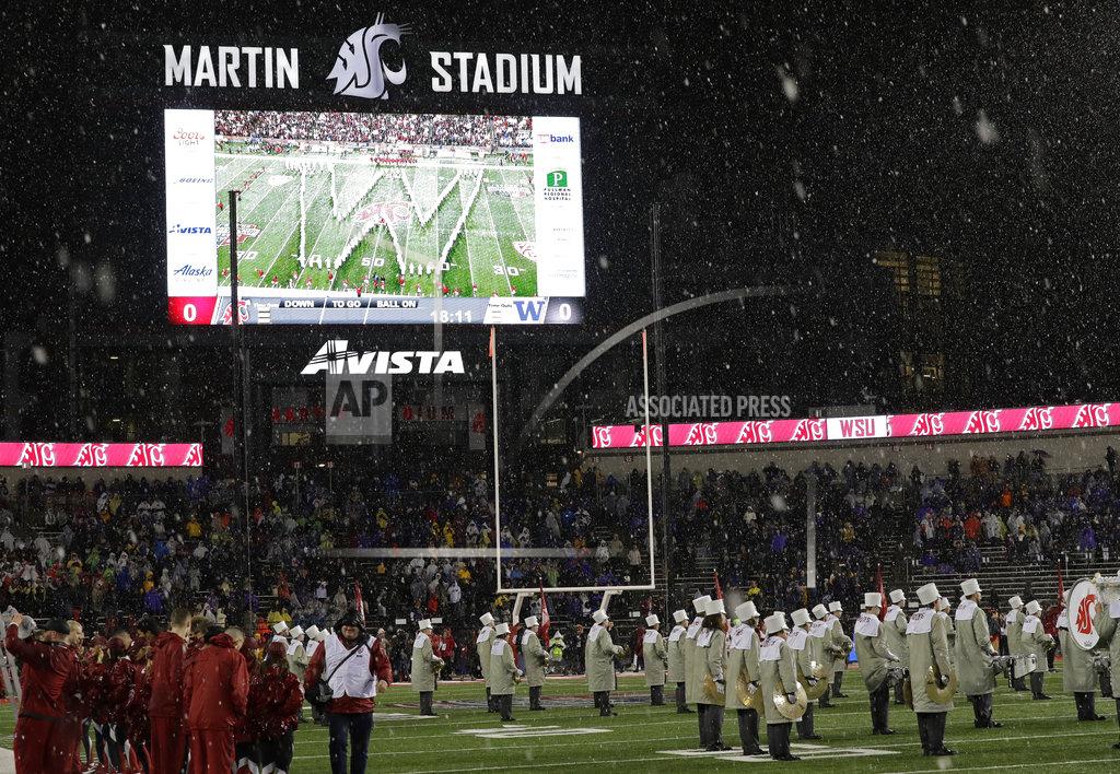 Ted S. Warren The Washington State marching band is shown in the W formation as they play the Washington fight song in a pre-game tribute to the Washington band, who were unable to perform at the Apple Cup NCAA college football game due to one of their buses crashing Thursday night, Friday, Nov. 23, 2018, in Pullman, Wash. (AP Photo/Ted S. Warren)
