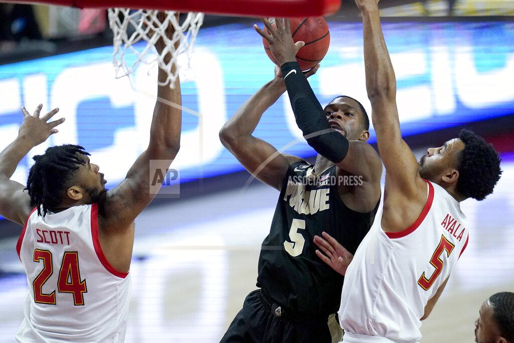 Julio Cortez Purdue guard Brandon Newman, center, goes up for a shot against Maryland guard Eric Ayala, right, and forward Donta Scott during the first half of an NCAA college basketball game, Tuesday, Feb. 2, 2021, in College Park. (AP Photo/Julio Cortez)