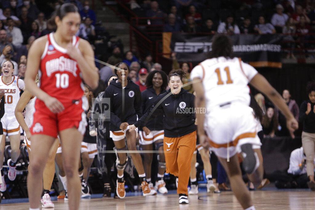 Young Kwak Texas bench players rush to greet guard Joanne Allen-Taylor (11) after Texas beat Ohio State 66-63 in a college basketball game in the Sweet 16 round of the NCAA tournament, Friday, March 25, 2022, in Spokane, Wash. (AP Photo/Young Kwak)