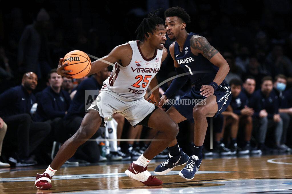 Adam Hunger Virginia Tech's Justyn Mutts (25) drives past Xavier's Paul Scruggs during the first half of an NCAA college basketball game in the NIT Season Tip-Off tournament Friday, Nov. 26, 2021, in New York. (AP Photo/Adam Hunger)