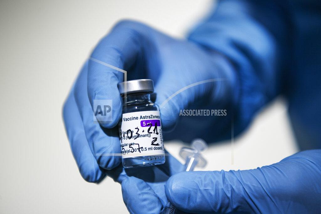 Fabio Ferrari A health worker holds up a vial of the AstraZeneca vaccine for COVID-19 at a vaccination center set up at the Allianz Stadium in Turin, northern Italy, Wednesday, March 24, 2021. Italian Government officials said on Wednesday doses of AstraZeneca vaccine at a packaging plant in central Italy were destined for Belgium, a statement that appeared to refute reports that the 29 million “hidden doses” were planned for export to Britain. (Fabio Ferrari/LaPresse via AP)