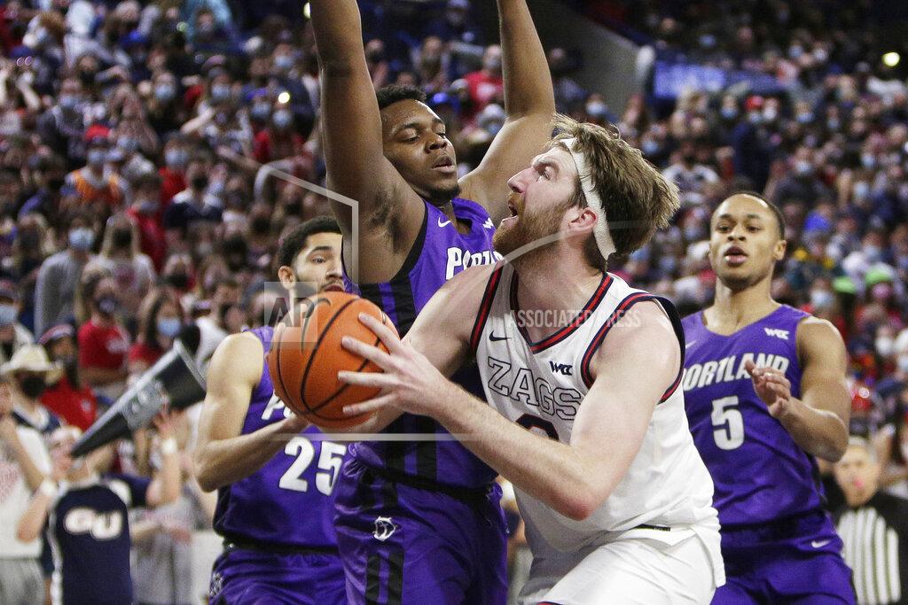Young Kwak Gonzaga forward Drew Timme, right, drives to the basket while pressured by Portland forward Chika Nduka during the first half of an NCAA college basketball game, Saturday, Jan. 29, 2022, in Spokane, Wash. (AP Photo/Young Kwak)