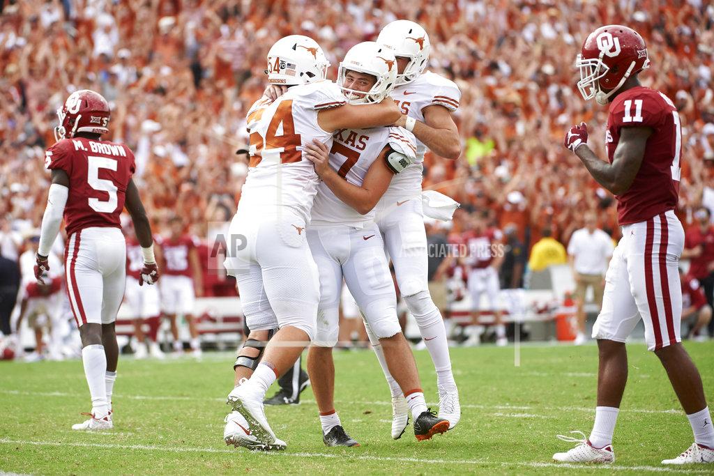 Cooper Neill Texas kicker Cameron Dicker (17) celebrates with teammates after kicking the game-winning field goal in the closing seconds of the second half of an NCAA college football game against Oklahoma at the Cotton Bowl, Saturday, Oct. 6, 2018, in Dallas. Texas won 48-45. (AP Photo/Cooper Neill)