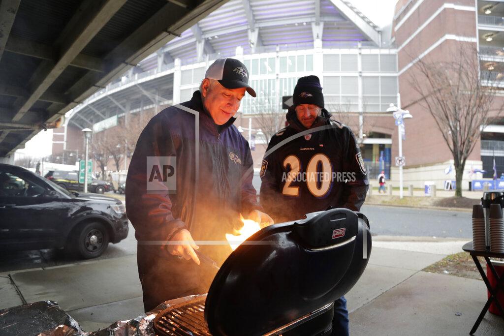 Julio Cortez Allen Schiff grilling burgers while tailgating in the parking lot before the start of an NFL football game between the Baltimore Ravens and the San Francisco 49ers, Sunday, Dec. 1, 2019, in Baltimore, Md. (AP Photo/Julio Cortez)