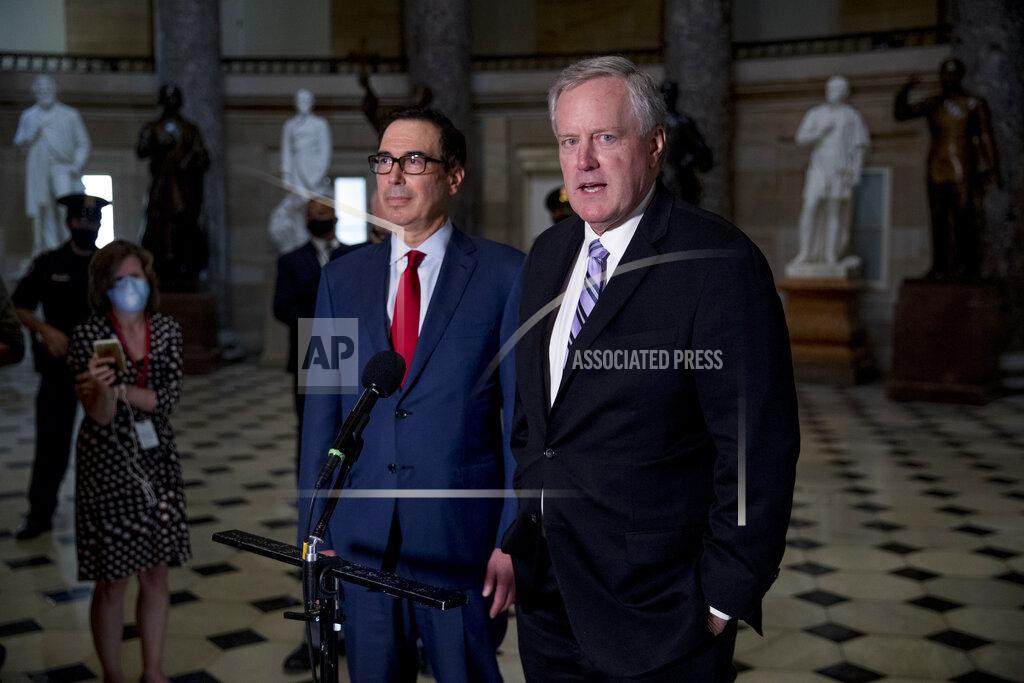 White House Chief of Staff Mark Meadows, right, accompanied by Treasury Secretary Steven Mnuchin, left, speaks to reporters after meeting with House Speaker Nancy Pelosi of Calif. and Senate Minority Leader Sen. Chuck Schumer of N.Y. as they continue to negotiate a coronavirus relief package on Capitol Hill in Washington, Friday, Aug. 7, 2020. (AP Photo/Andrew Harnik)