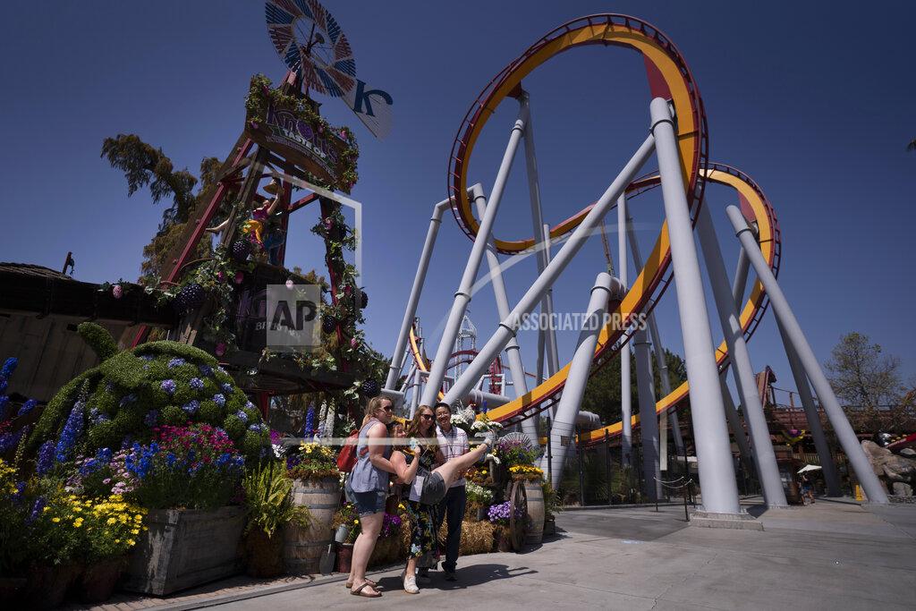 Jae C. Hong Visitors pose for photos during the Knott's Taste of Boysenberry Festival at Knott's Berry Farm in Buena Park, Calif., Tuesday, March 30, 2021. Massive Los Angeles County can reopen even more businesses, California public health officials announced Tuesday. The county of 10 million people was one of several counties, including neighboring Orange County, that moved into the state's second-least restrictive orange tier amid low coronavirus case rates. (AP Photo/Jae C. Hong)