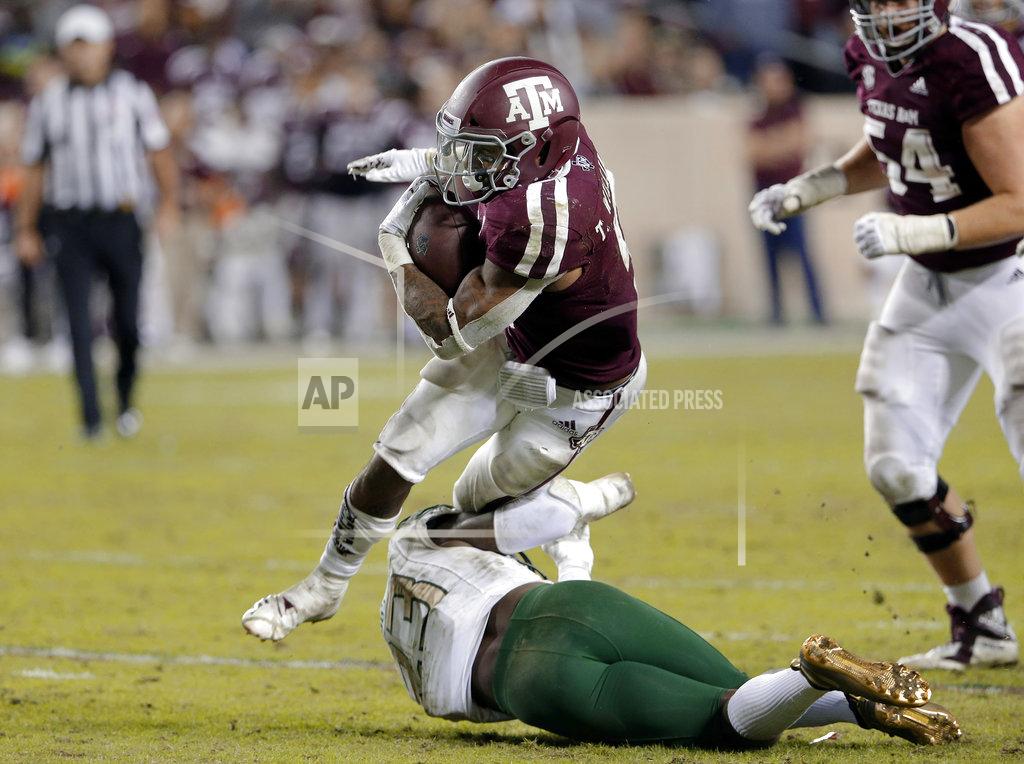 Michael Wyke Texas A&M running back Trayveon Williams, top, is caught by UAB safety Mar'Sean Diggs (23) during the second half of an NCAA college football game Saturday, Nov. 17, 2018, in College Station, Texas. (AP Photo/Michael Wyke)