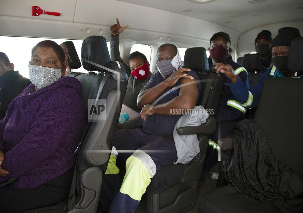 Denis Farrell People sit in a minibus vehicle prior to be vaccinated, at the Houghton Mosque, which is being used as a drive-thru COVID-19 vaccination centre in Johannesburg Wednesday, July 28, 2021. Hitting its stride after a faltering start, South Africa’s mass vaccination campaign gave jabs to 220,000 people a day last week and is accelerating toward the goal of 300,000 per day. With large deliveries of doses arriving and some vaccines being assembled here, South Africa appears on track to inoculate about 35 million of its 60 million people by the end of the year. (AP Photo/Denis Farrell)