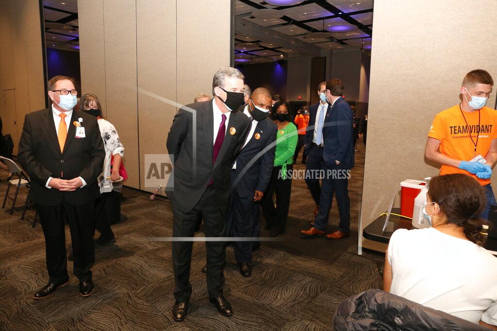 Deborah Griffin North Carolina Gov. Roy Cooper tours the Vidant Health/Pitt County large-scale COVID-19 vaccination clinic at the Greenville Convention Center in Greenville, N.C., Friday, March 19, 2021. (Deborah Griffin/The Daily Reflector via AP)