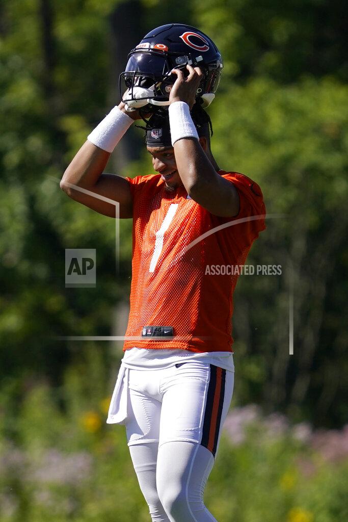 Nam Huh Chicago Bears quarterback Justin Fields puts on his helmet during the NFL football team's training camp, Saturday, July 30, 2022, in Lake Forest, Ill. (AP Photo/Nam Y. Huh)