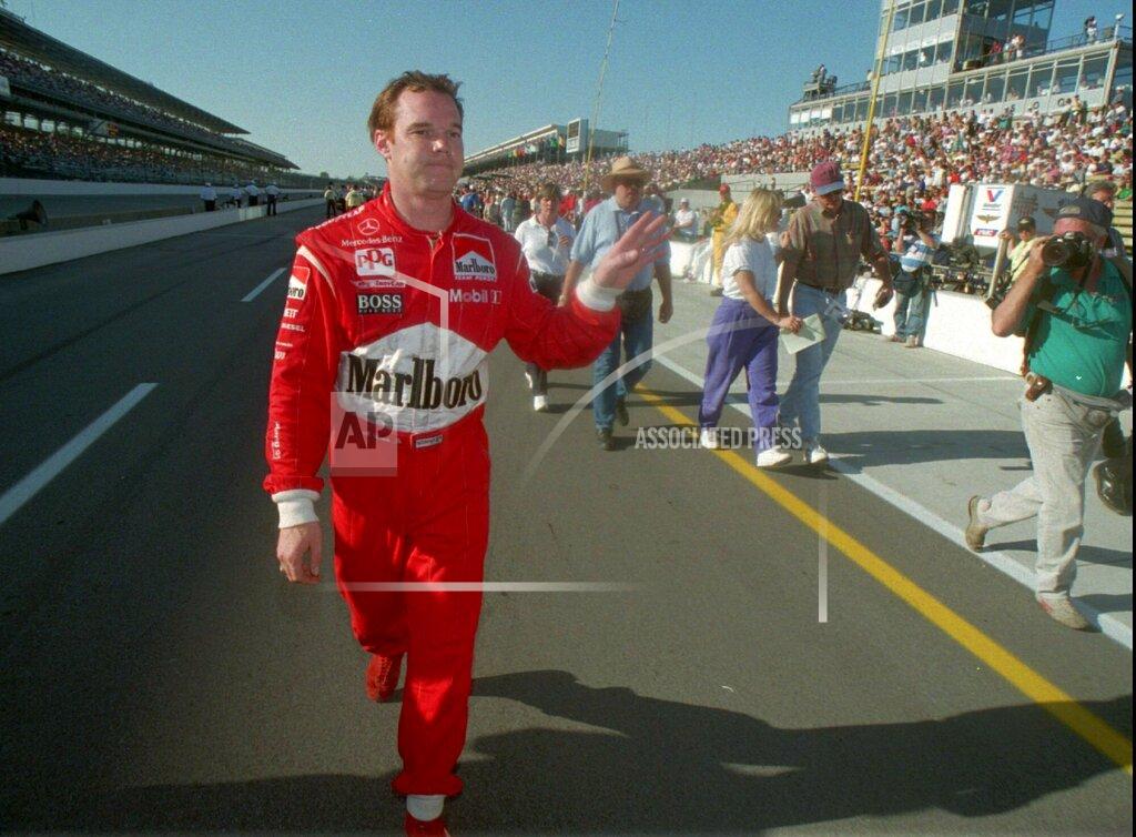 Aaron Wilson FILE - In this May 20, 1995, file photo, Al Unser Jr. waves after he failed to qualify for the 1995 Indianapolis 500, in Indianapolis, Ind. Chip Ganassi and Michael Andretti have joined Roger Penske in calling for guaranteed spots in the Indianapolis 500. The team owners argue their financial commitment to IndyCar is too steep to afford missing out on the biggest race of the year. (Aaron Wilson/The Albuquerque Journal via AP, File)